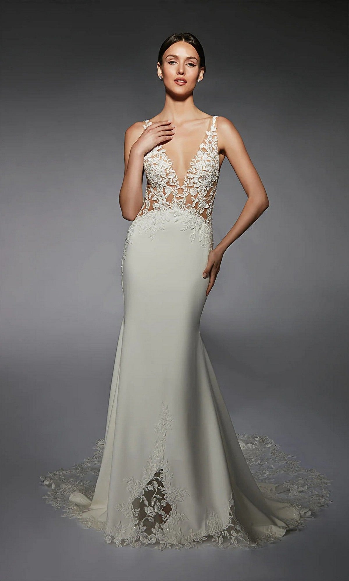 A woman wearing the Alyce 7117 Long White Dress with a sheer lace bodice and floral appliqué details, standing against a neutral background.